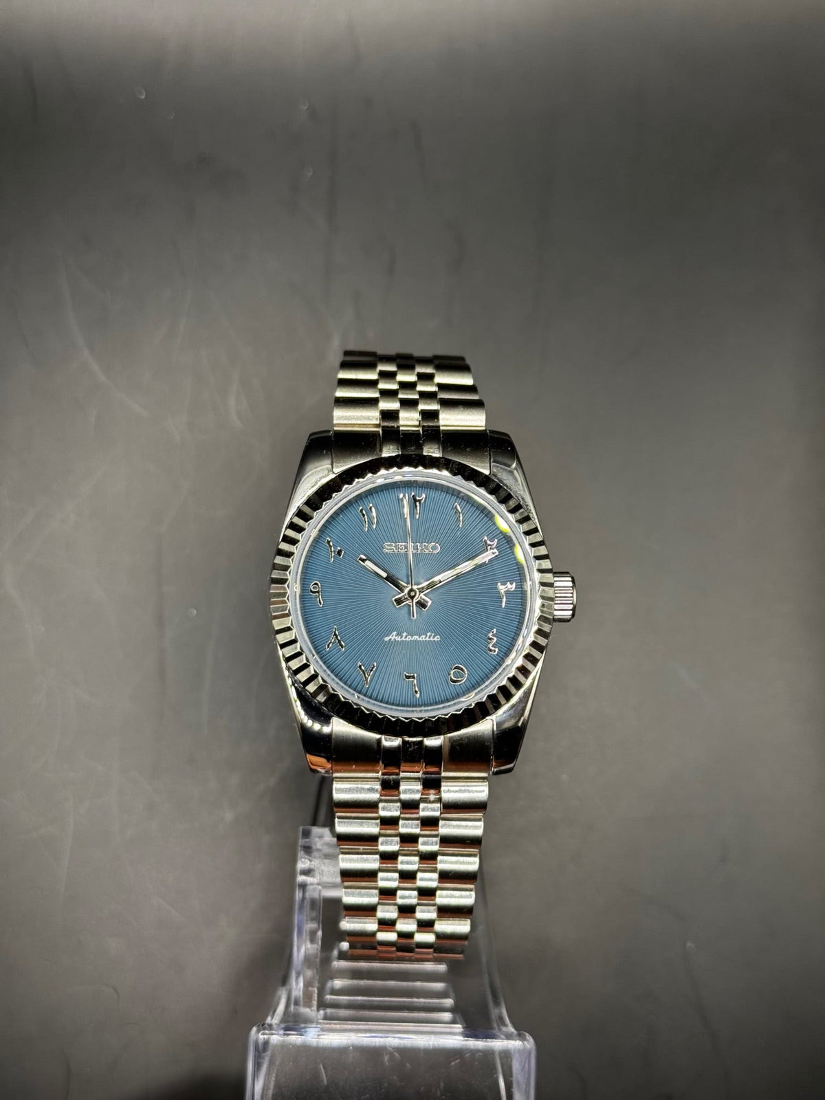 Seiko Arabic Navy Blue 36mm watch on a display stand