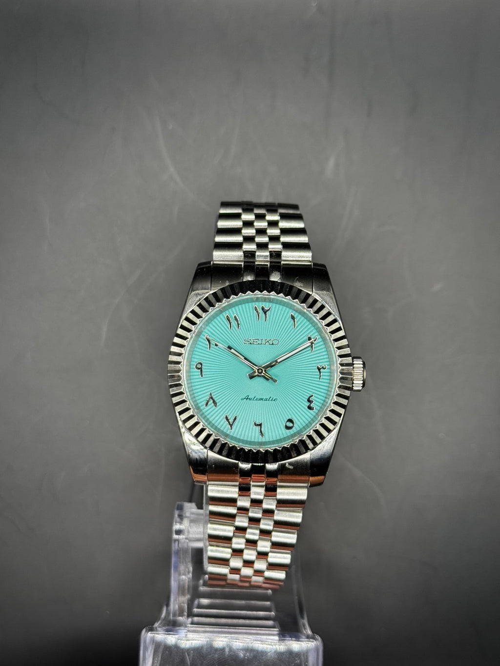 Seiko Arabic Tiffany Blue 36mm watch on a display stand