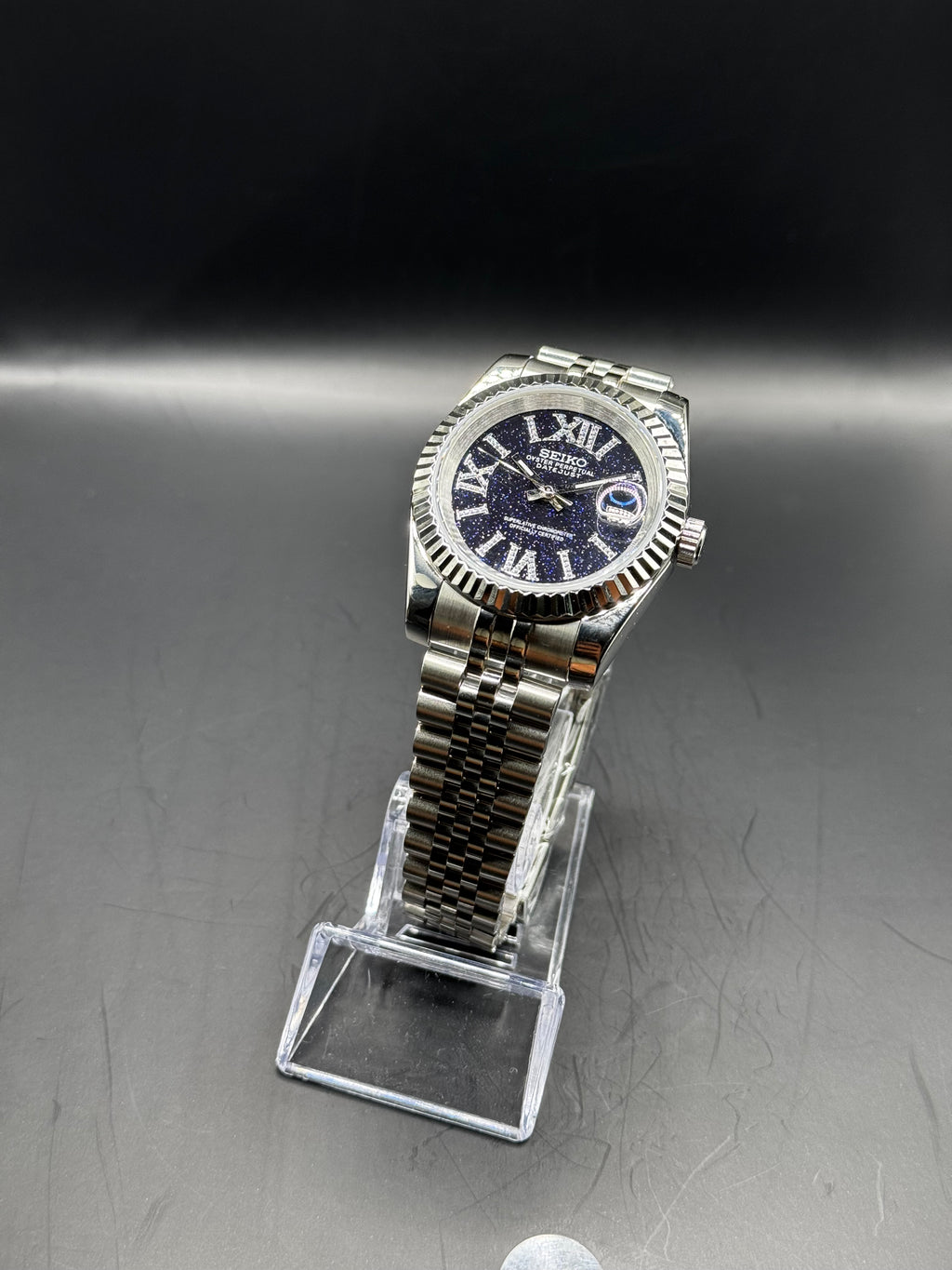 Seiko Roman Stardust 36mm watch on a display stand