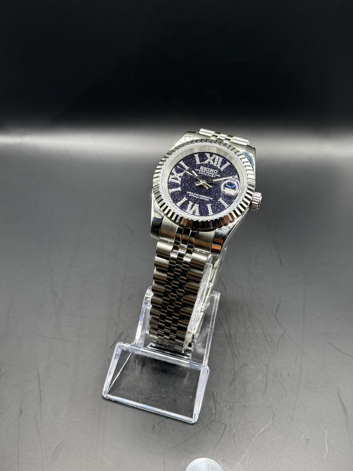 Seiko Roman Stardust 36mm watch on a display stand